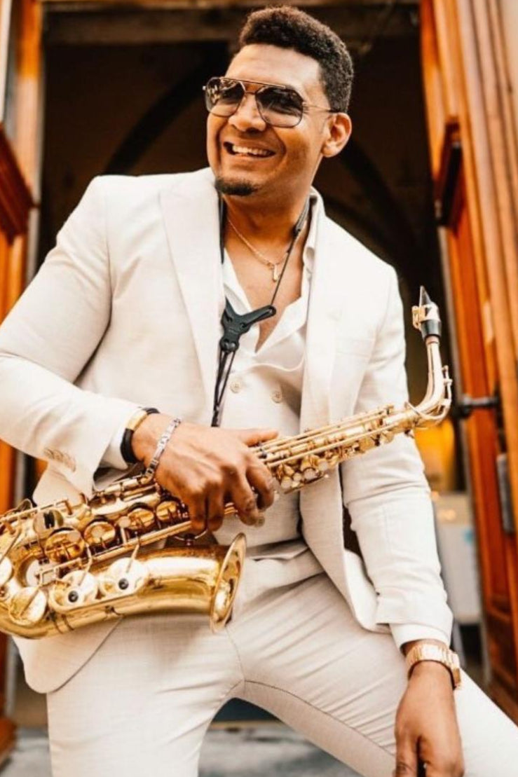 Man playing a saxophone in an elegant indoor setting