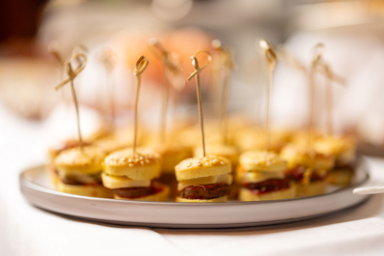 Platter of small appetizers with toothpicks on a blurred background
